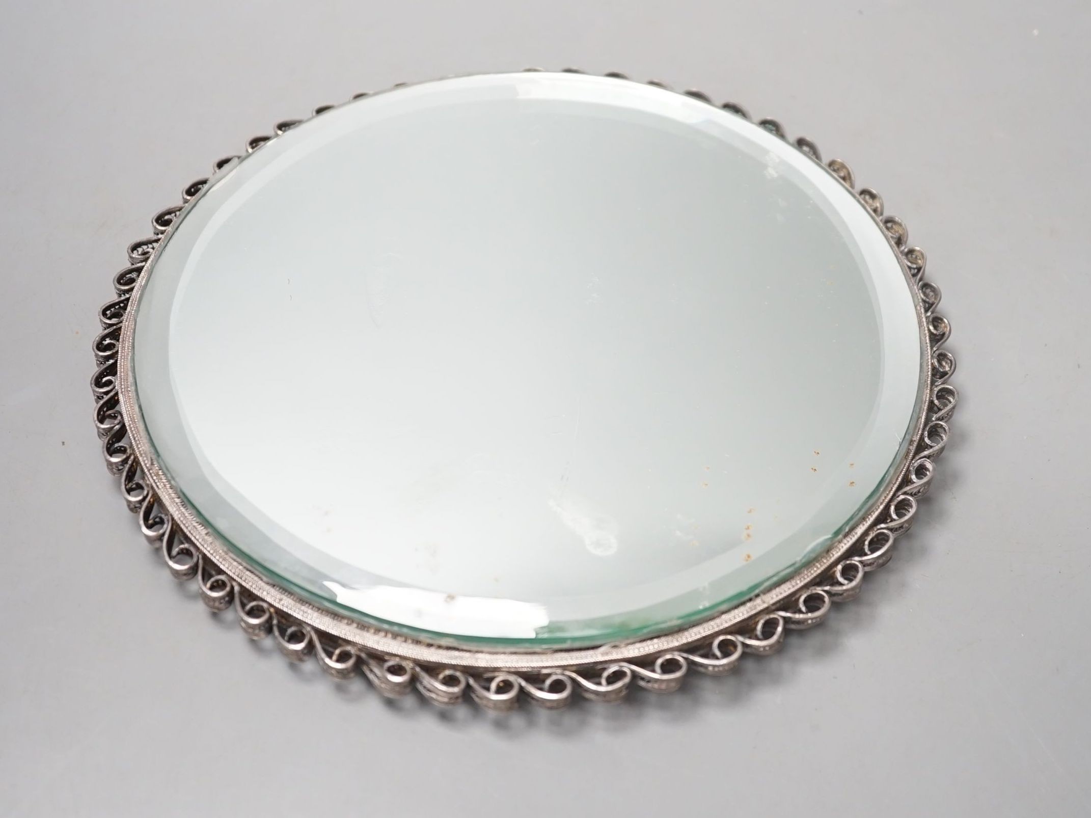 An Indian Goanese circular filigree work mirror, 23 cms diameter.